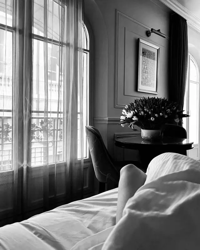Elegant hotel room with a large window, black and white