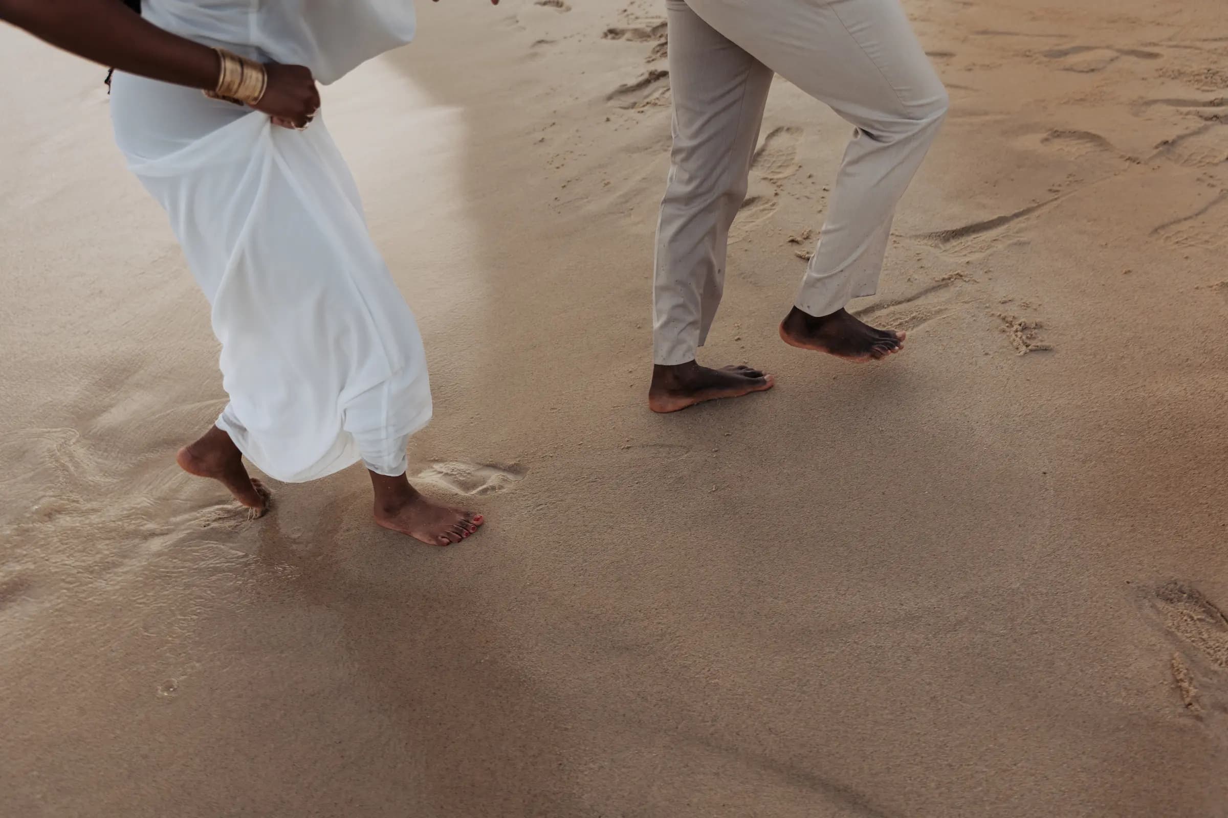 The beach proposal setup in Cabo with floral arrangements by the sea, black and white